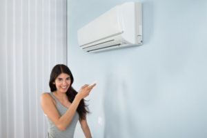 Woman Pointing to Air Conditioning