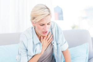Woman Clutching chest Allergies