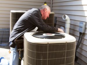 Man Inspecting Air Conditioner AC