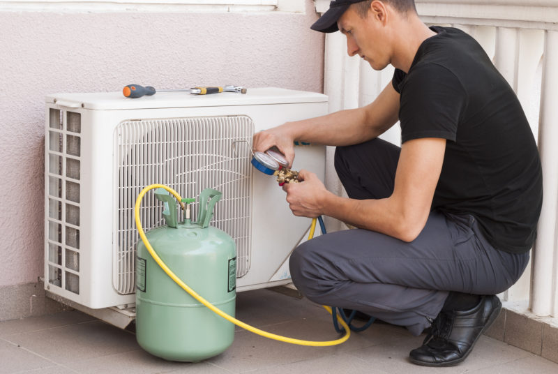 Man Checking Air Conditioning System