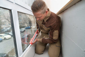 Man Sealing Window
